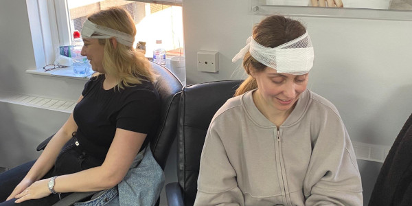 Two First Aid at Work delegates wearing head bandages