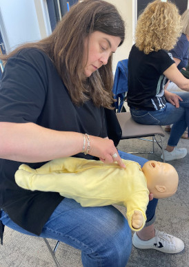 annual-paediatric-update Woman performing CPR on infant manikin